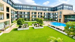 an exterior view of a building with a large yard at EMBASSY - Sky Suites in Accra