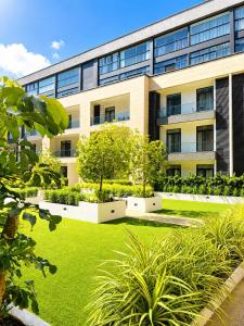an office building with a lawn in front of it at EMBASSY - Sky Suites in Accra