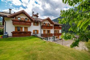 a large house with a lawn in front of it at Casa Bamby in Cogolo