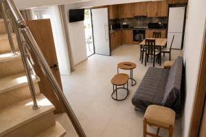 a living room and kitchen with a couch and a table at Karies House in Kefalos +13 photos