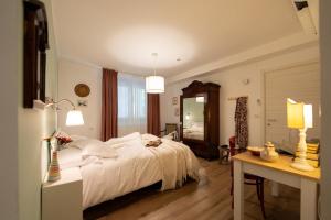 a bedroom with a bed and a table and a mirror at RossoMattone CountryHouse in Sulmona