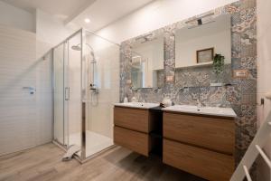 a bathroom with two sinks and a shower at RossoMattone CountryHouse in Sulmona +54 photos