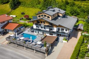 an aerial view of a house with a swimming pool at Aparthotel Fuxbau in Flachau