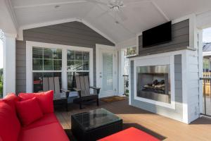 a living room with a red couch and a fireplace at Jellystone Park TM Petoskey in Petoskey
