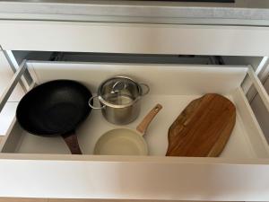 a drawer with a pot and a pan and a wooden spoon at Apartmant Beatrice in Veselé