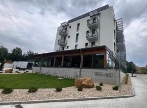 a large white building with a yard in front of it at Apartmant Beatrice in Veselé