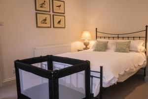 a bedroom with a large bed and a tv at Oaters Wood in Petworth