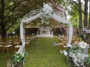 an outdoor ceremony with a gazebo with chairs and flowers at Preston House in Abbeyleix