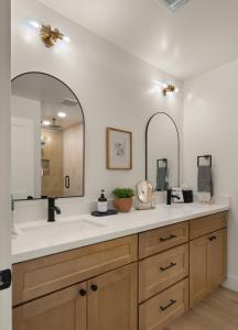 a bathroom with a sink and a large mirror at Page House in Gilbert +52 photos