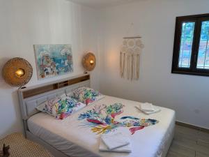 a bedroom with a bed with two pillows on it at T2 "Bohême" vue mer, centre ville tout à pied in Le Lavandou