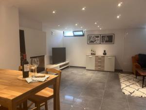 a dining room and living room with a table and chairs at Vivienda Turística Lorena in Cascante