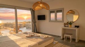 a bedroom with a bed and a view of the ocean at Erimo Vip in Vourvoúlos