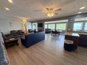 a living room with a couch and a ceiling fan at Lake Access Retreat Pet Friendly Fire Pit in Geneva