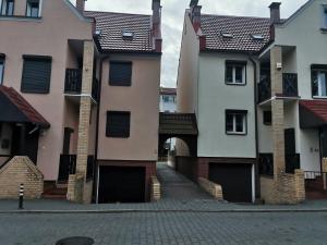a row of buildings with a gate and a street at Elen & K in Polkowice