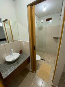 a bathroom with a sink and a toilet at Hospedagem De Ferias in Bonito +45 photos