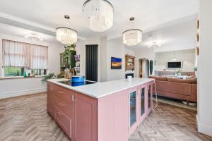 a kitchen and living room with a couch at Hillsley House in Wirksworth