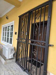 a black gate with a door to a house at Luxury Home Away in Aja
