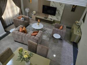 an overhead view of a living room with couches and a television at Luxury Home Away in Aja