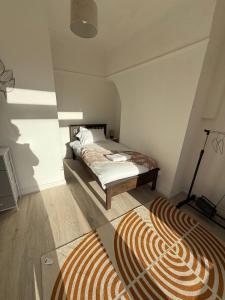 a bedroom with a bed and a rug on the floor at Short Stay & Long Stay home in Ellesmere Port in Little Sutton