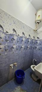 a bathroom with a wall covered in bird graffiti at JSM DELUXE Ac in Vellore