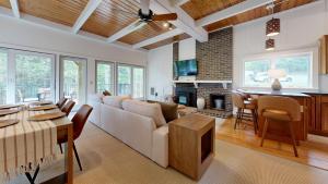 a living room with a white couch and a fireplace at Quechee's Cloud 9 in Hartford