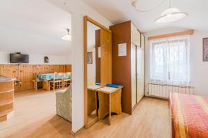 a bedroom with a bed and a desk in a room at Turistična kmetija Široko in Tolmin