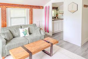 a living room with a couch and a coffee table at Cute Stowe Apartment in Stowe
