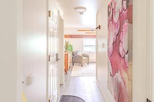 a hallway with a red painting on the wall at Cute Stowe Apartment in Stowe