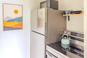 a kitchen with a refrigerator and a stove at Cute Stowe Apartment in Stowe +6 photos