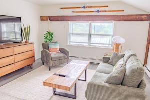 a living room with a couch and a coffee table at Cute Stowe Apartment in Stowe
