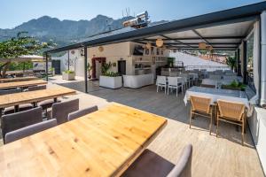 a patio with wooden tables and chairs and a restaurant at The Turunç INN Otel in Turunç +37 photos