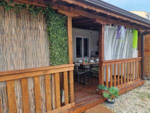 a wooden gazebo with a patio with a table at Bungalows Rea in Burgas