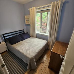 a small bedroom with a bed and a window at Location Location Location in Stratford