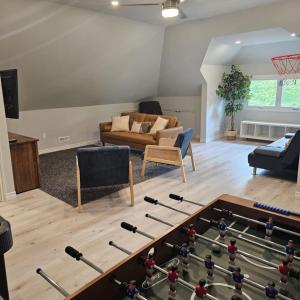 a living room with a table with a game of dominoes at Location Location Location in Stratford