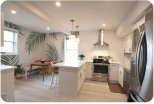 a kitchen with a counter and a table in it at Location Location Location in Stratford