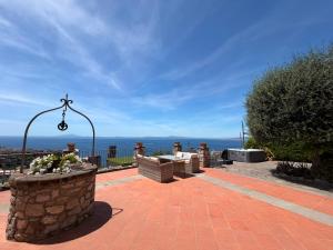 a brick patio with a view of the ocean at Corte Degli Ulivi Resort in Vico Equense +76 photos