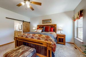 a bedroom with a bed and a ceiling fan at Quartz Court in Pagosa Springs +52 photos