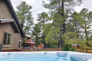 a swimming pool in front of a house with trees at Quartz Court in Pagosa Springs