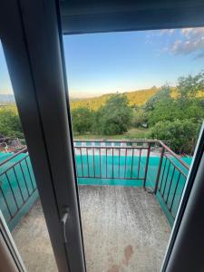 a view from a window of a balcony with a pool at Jagoda IN in Otroci
