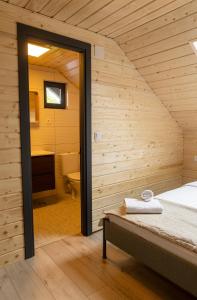 a room with a bed and a bathroom at Meștera 9 in Stînceni