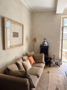 a living room with a couch and a man on a table at La Brèche - Mansion with swimming pool in Velleron +31 photos