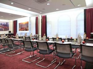 a conference room with tables and chairs in a building at Mercure München City Center in Munich