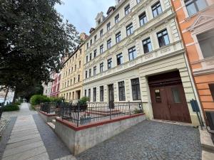 a large building with a brown door on a street at Ebram Apartments Görlitz in Görlitz