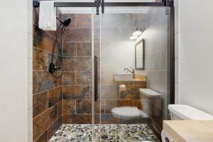 a bathroom with a shower with a toilet and a sink at Valley Vista Vacay 2 in Littleton +27 photos