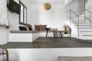 a living room with a couch and a table at Tzitziki in Piso Livadi