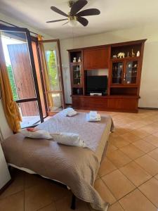 a bedroom with a bed and a flat screen tv at Casa Aurora Gardalake in Cavalcaselle
