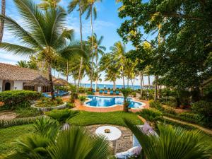 an aerial view of a resort with a pool and palm trees at Asha Boutique Hotel in Diani Beach