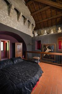 a bedroom with a large bed in a room at Torre Caetani- Night in a medieval tower in Todi