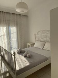 a bedroom with a bed with two towels on it at Georgia's House Olympiada in Olympiada