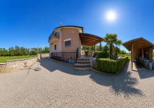 a building with a staircase in front of a house at Galizana Peaceful Vacation home in Galižana